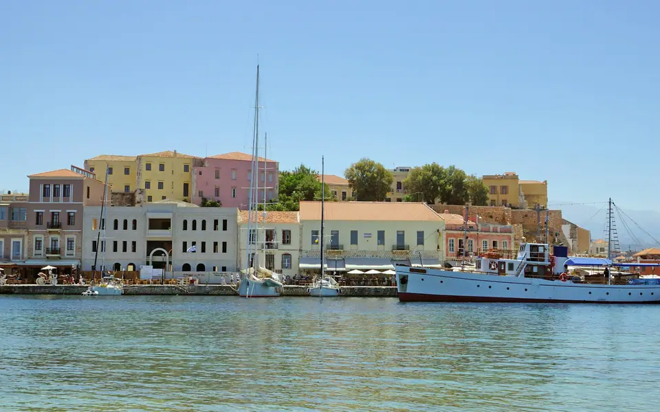 Waterfront buildings and boats in Chania's old harbour, Crete