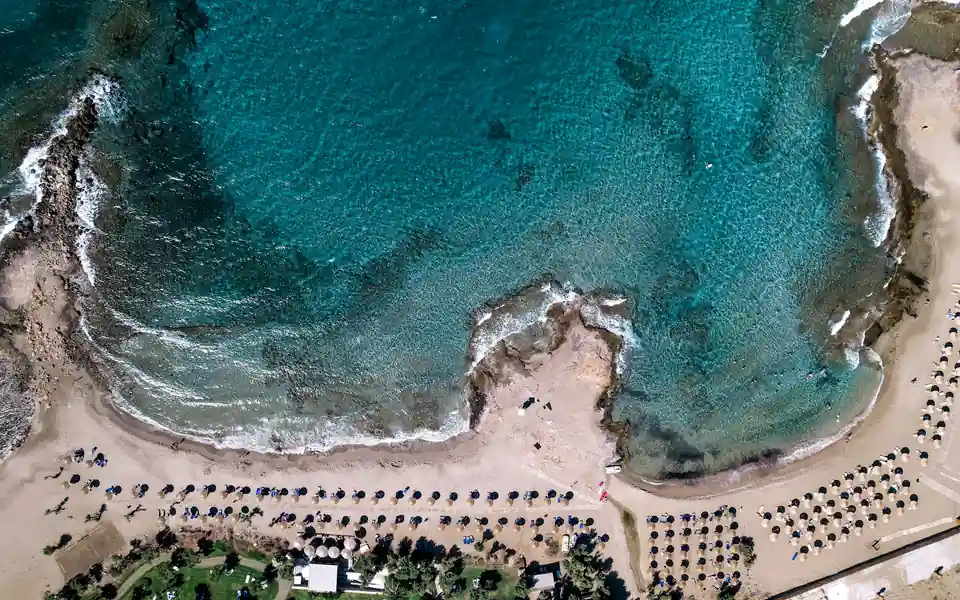 Aerial view of the beach and turquoise water at Malia, Crete