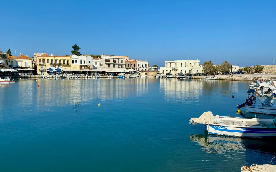 Fishing boats and waterfront buildings in Rethymno's old harbour, Crete